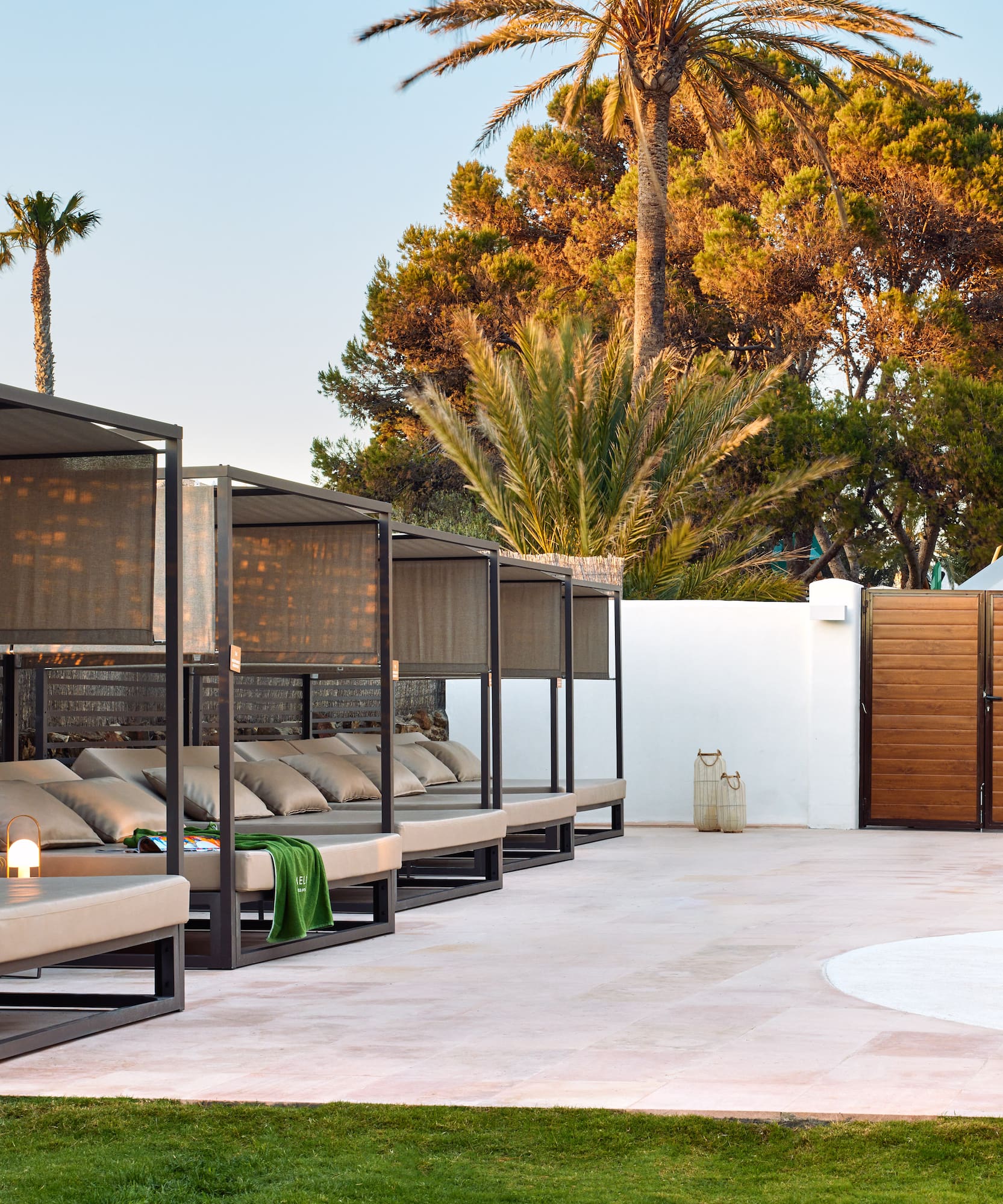 a pool with a lounge chair and a wood door