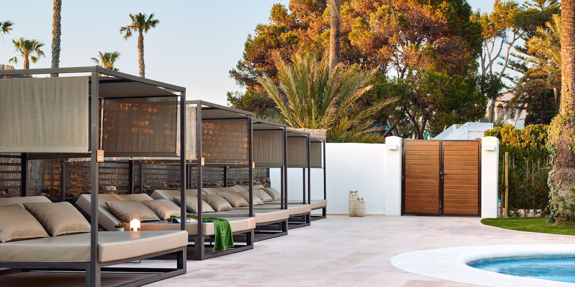 a pool with a lounge chair and a wood door