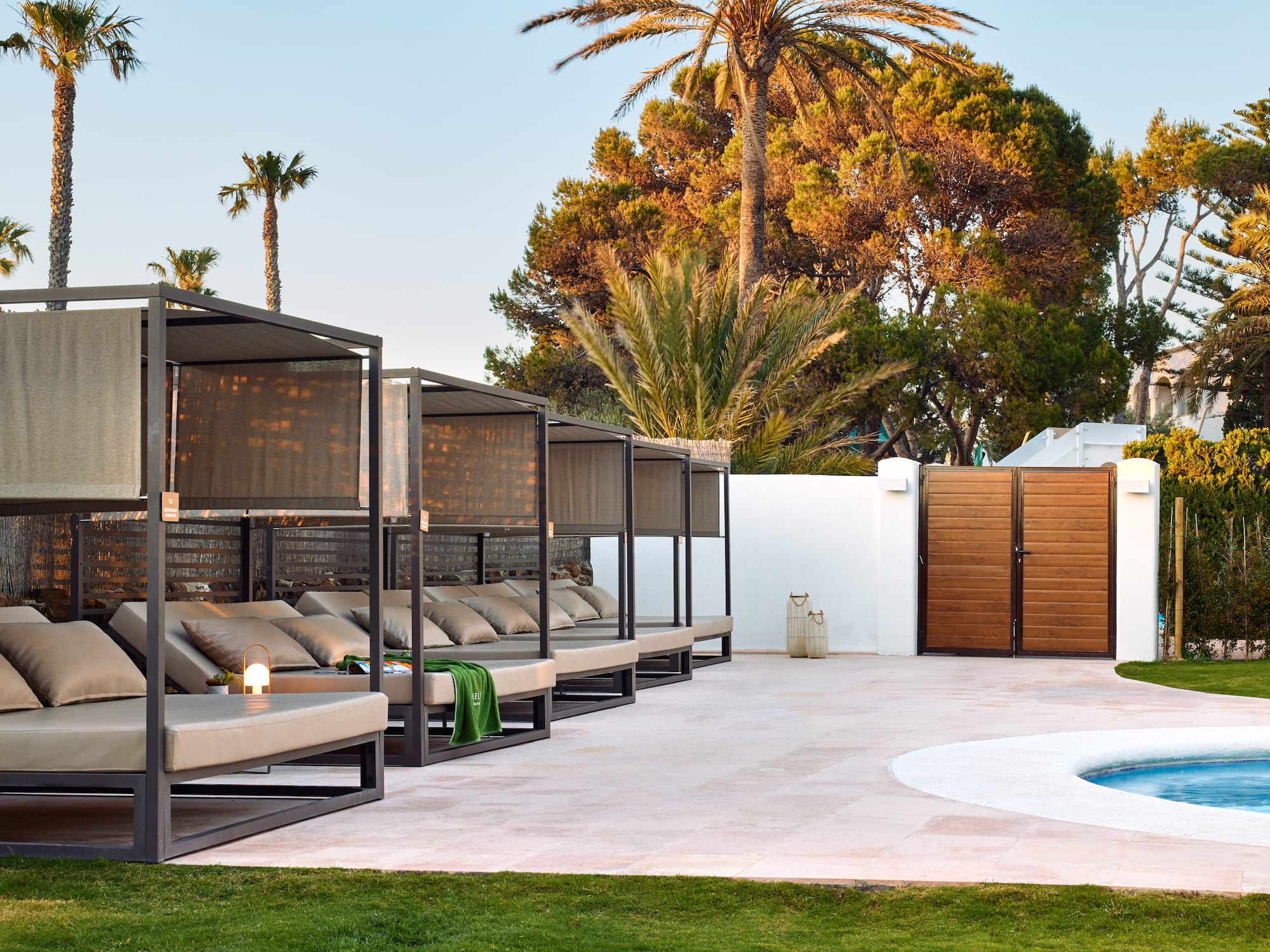 a pool with a lounge chair and a wood door