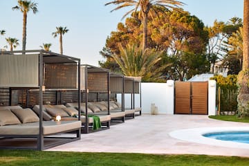 a pool with a lounge chair and a wood door