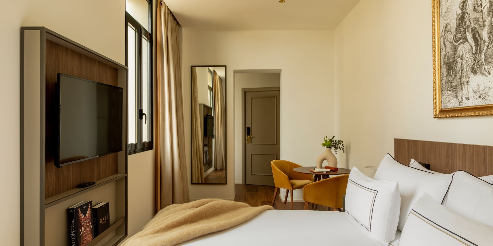 a bedroom with a tv and a bed