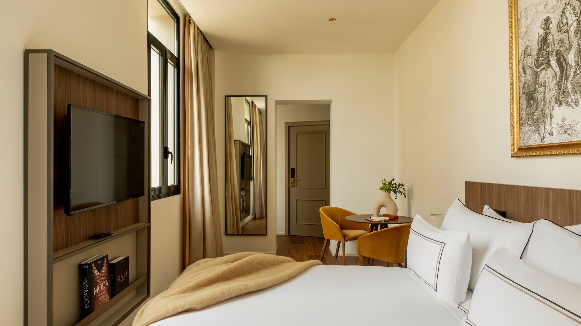 a bedroom with a tv and a bed