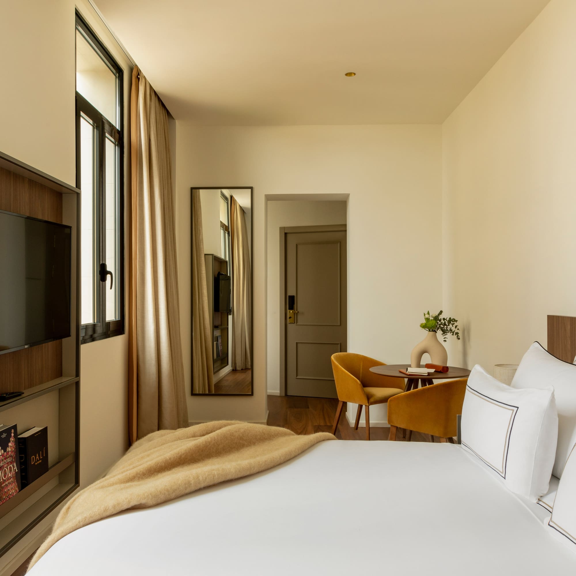 a bedroom with a tv and a bed