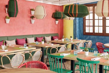 a colorful restaurant with tables and chairs