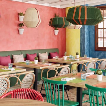 a colorful restaurant with tables and chairs