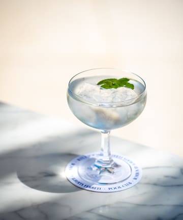 a glass of water with ice and mint leaves