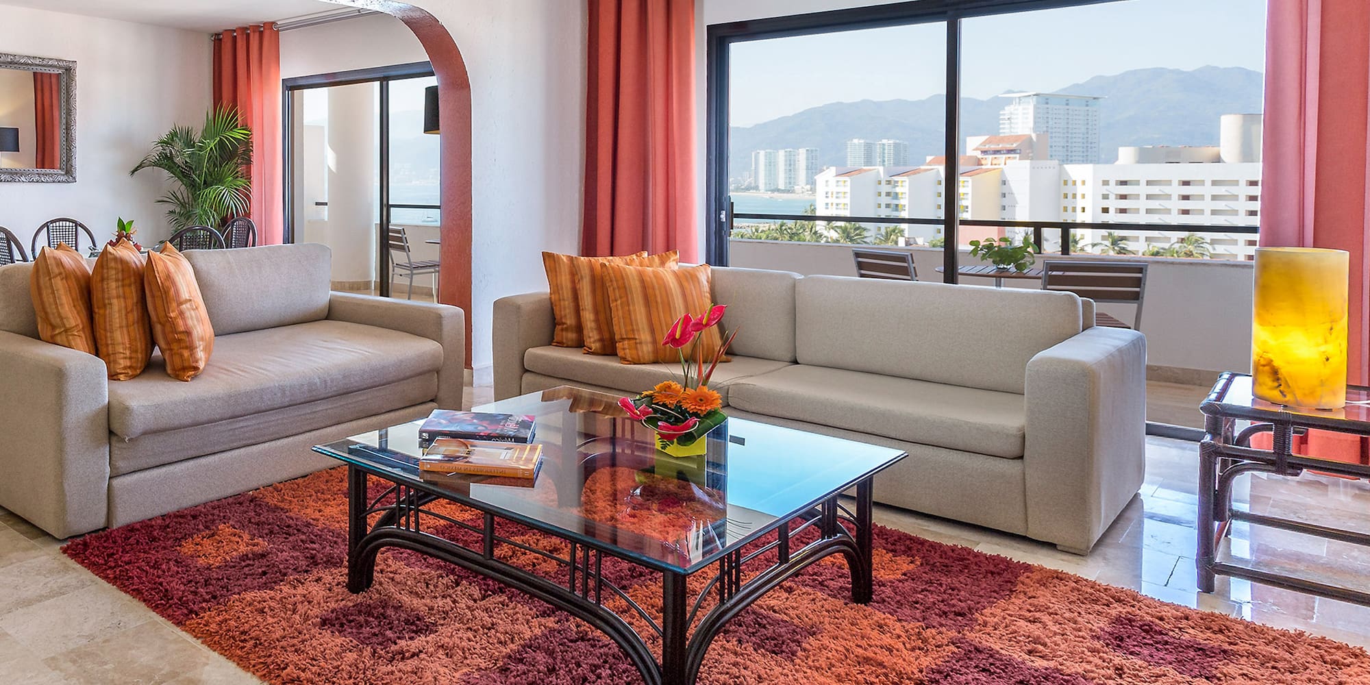 a living room with couches and a glass coffee table