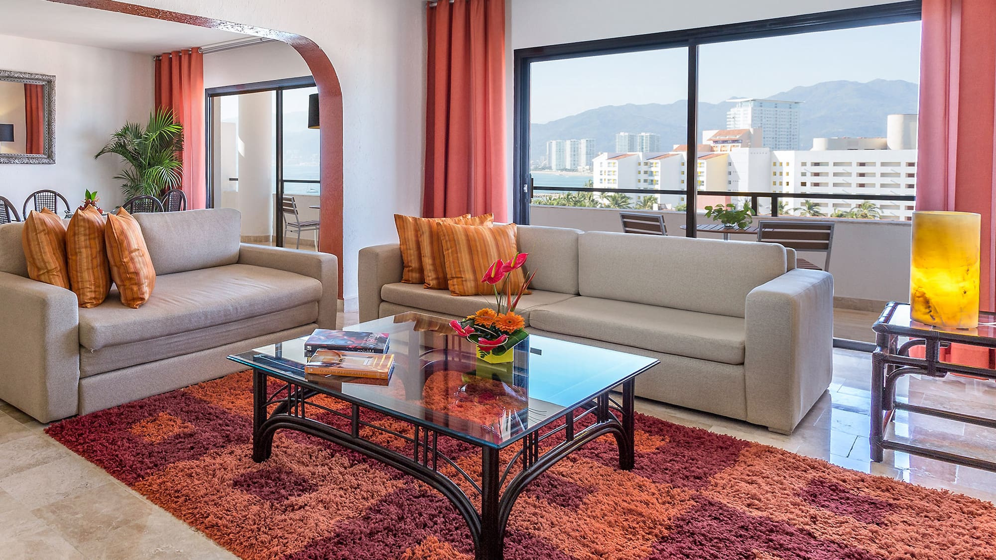 a living room with couches and a glass coffee table
