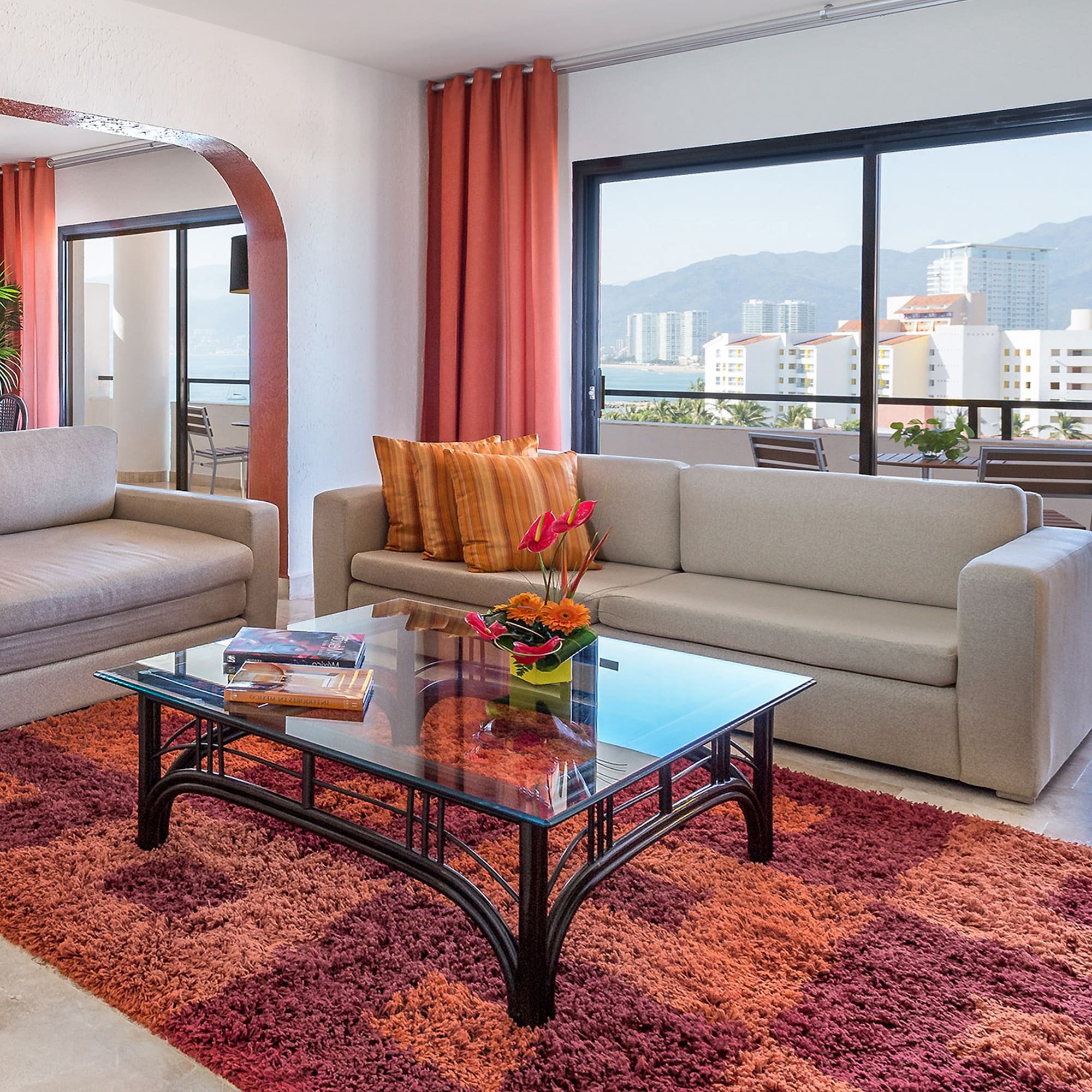 a living room with couches and a glass coffee table