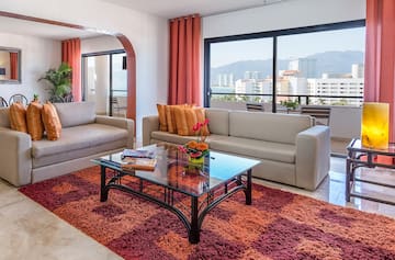 a living room with couches and a glass coffee table