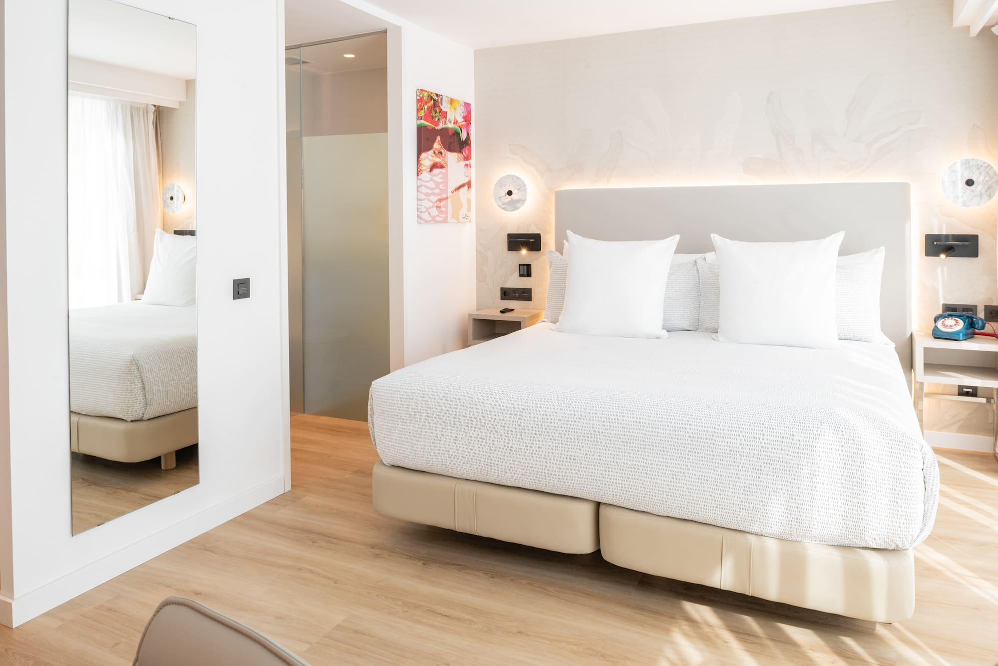 a bed with white pillows in a room