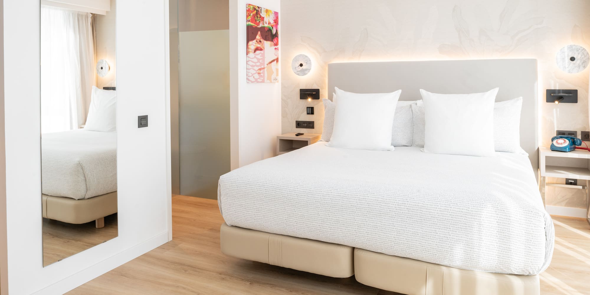 a bed with white pillows in a room