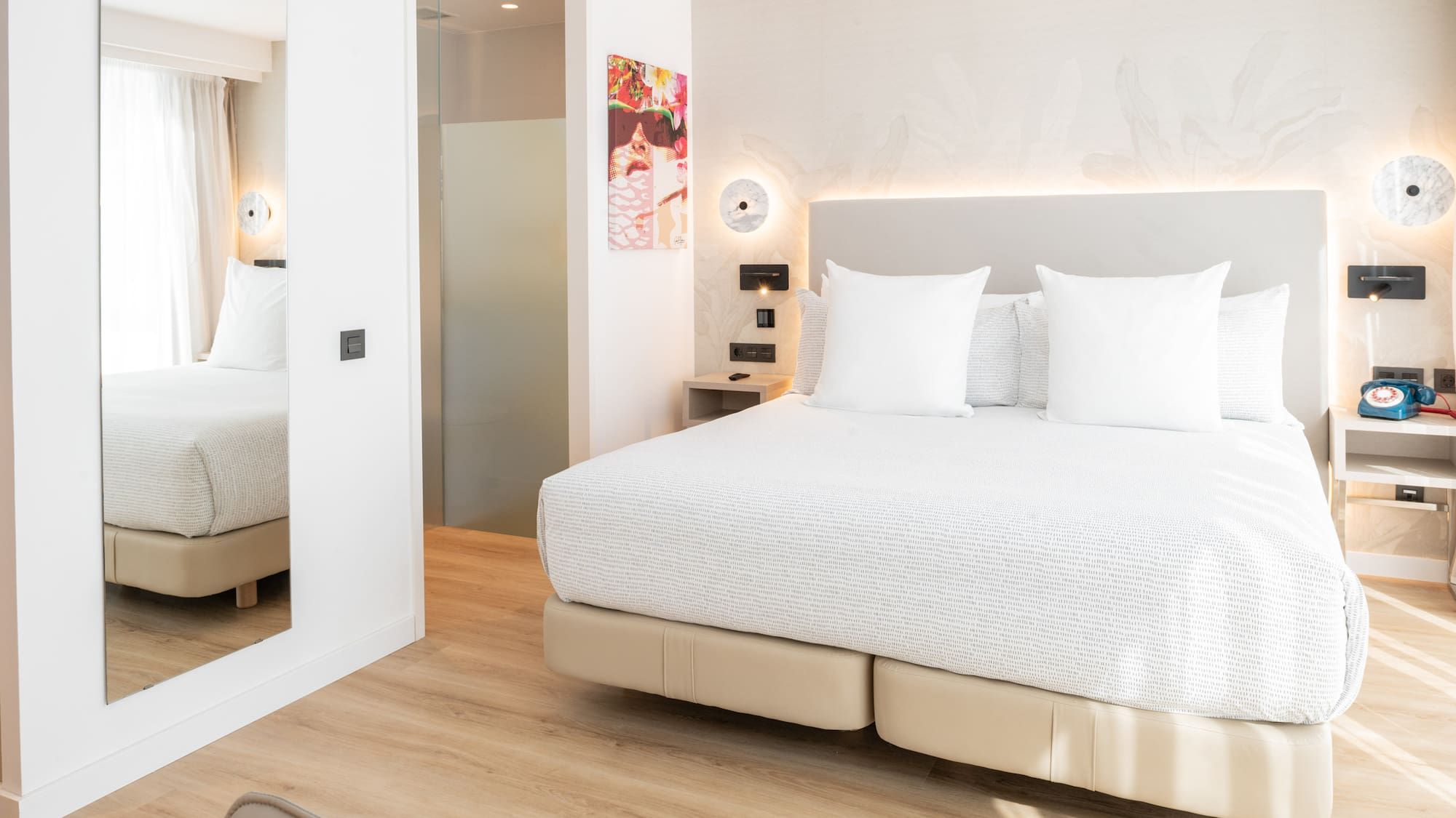 a bed with white pillows in a room