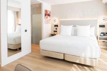 a bed with white pillows in a room