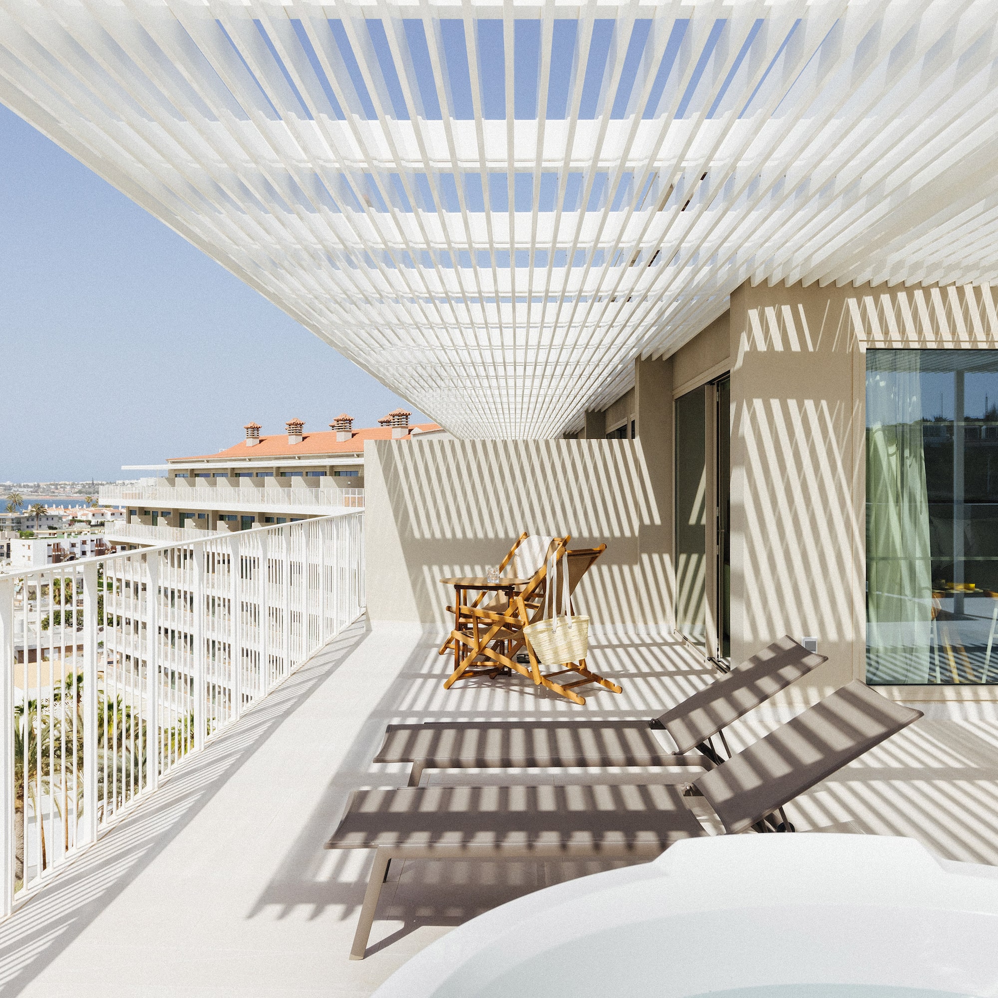 a deck with chairs and a hot tub