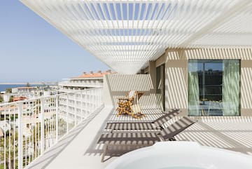 a deck with chairs and a hot tub