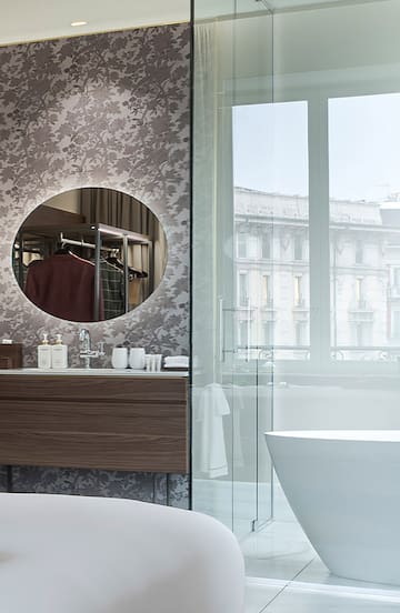 a bathroom with a mirror and a tub