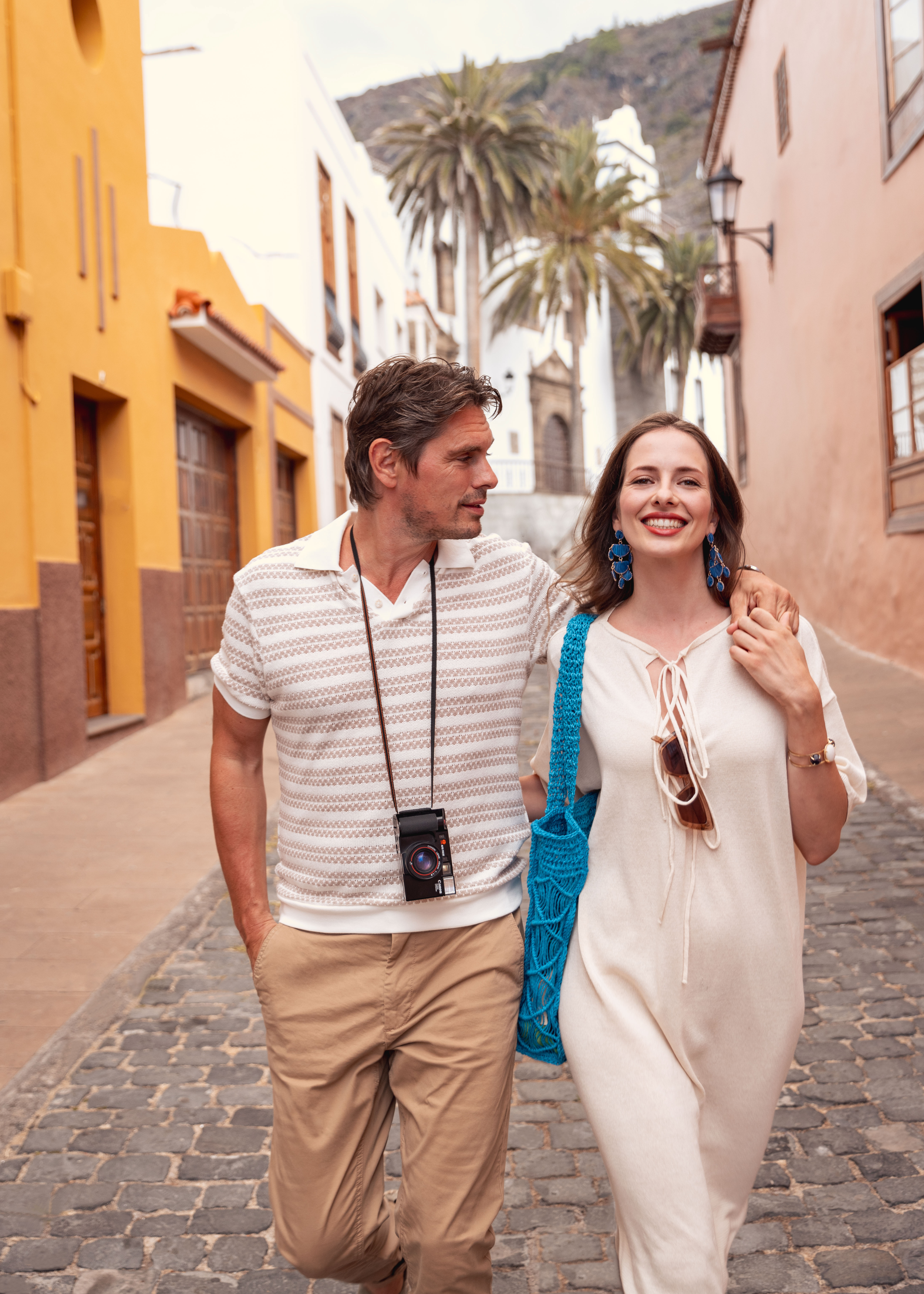 a man and woman walking down a street