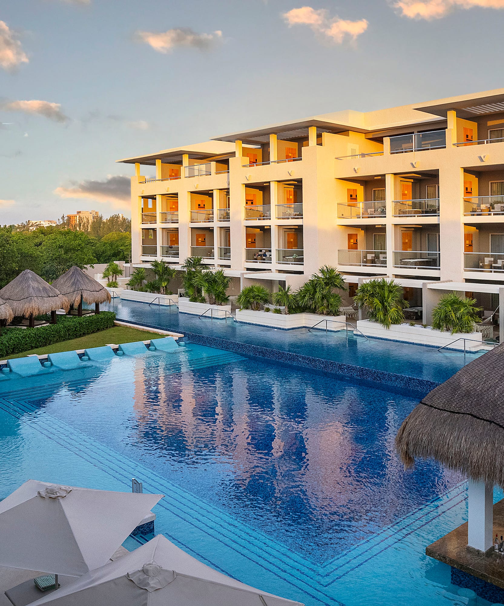 a pool with a building and trees