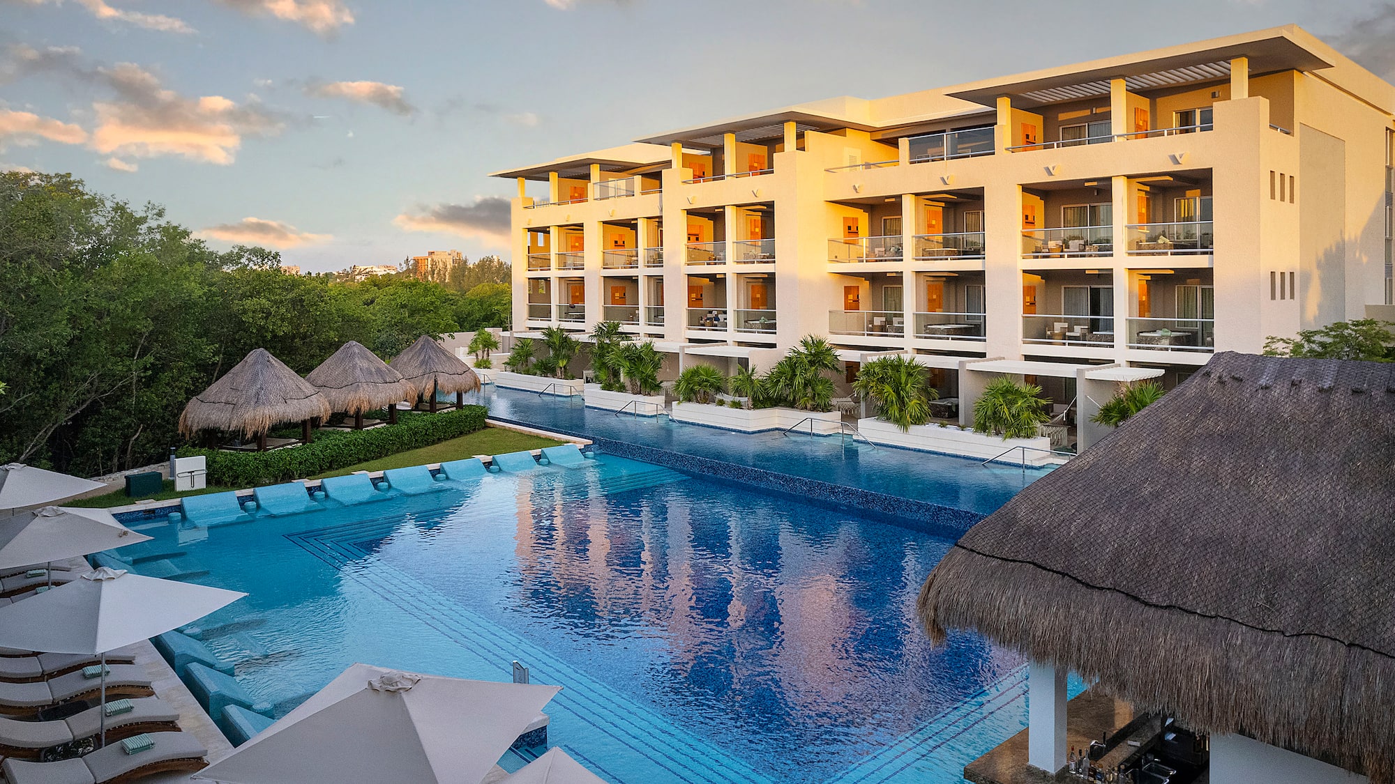 a pool with a building and trees