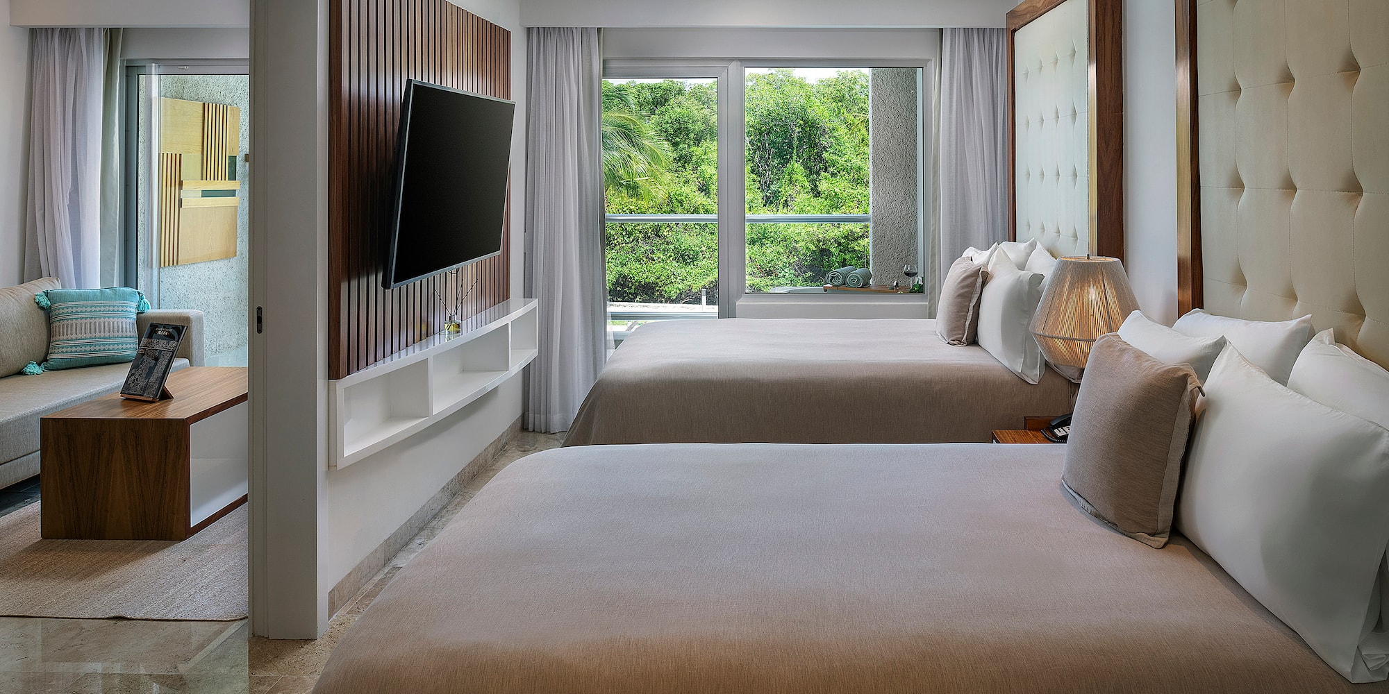 a room with two beds and a television