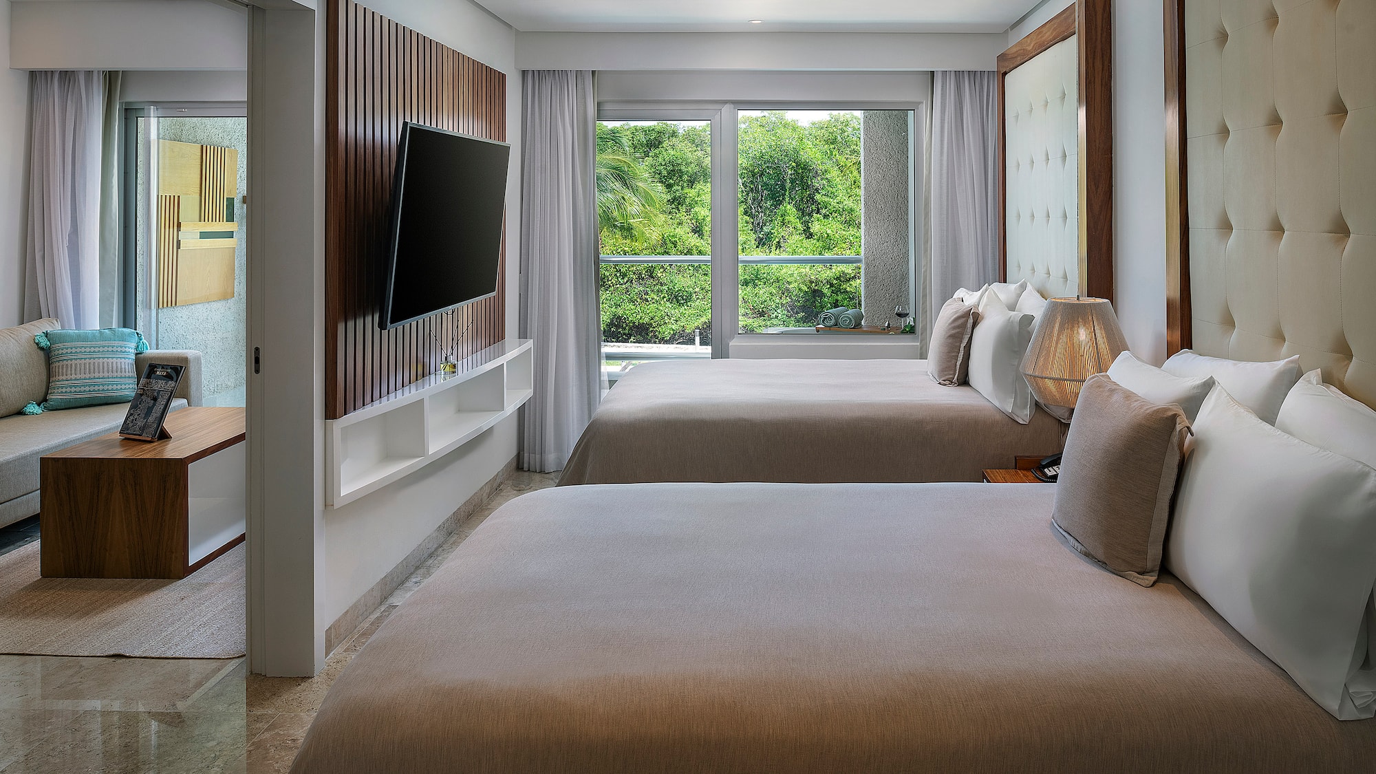 a room with two beds and a television