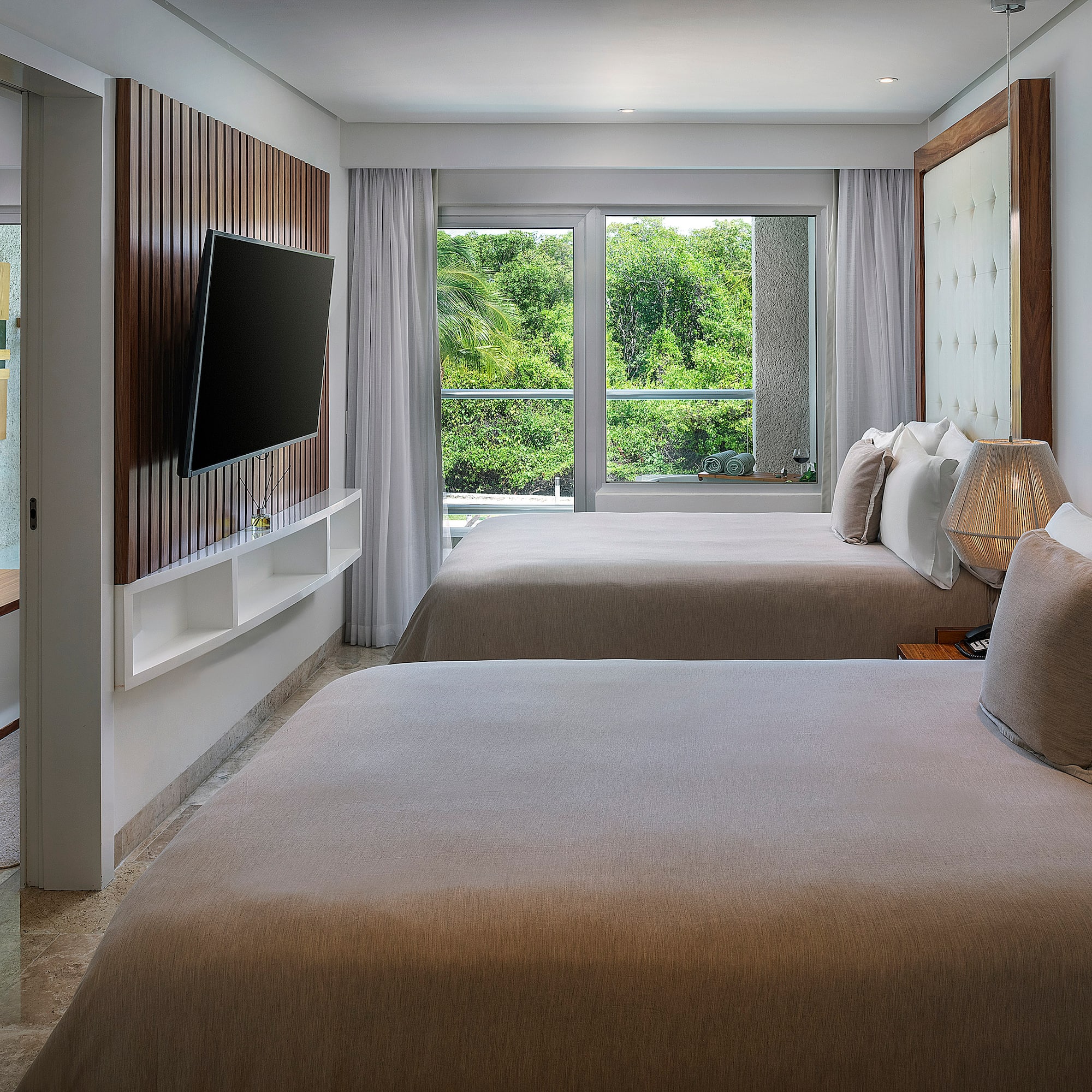 a room with two beds and a television