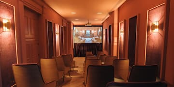 a room with chairs and a projector screen