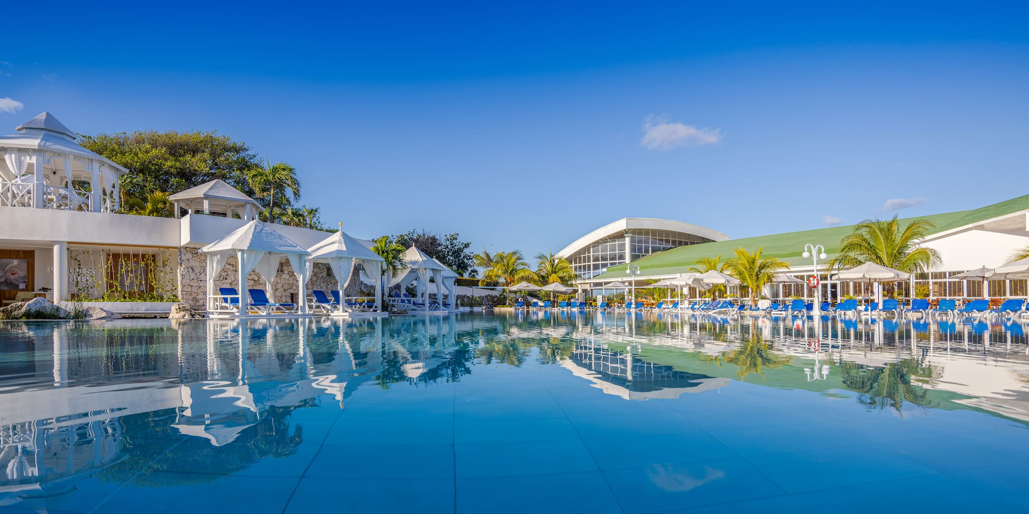 a pool with chairs and umbrellas