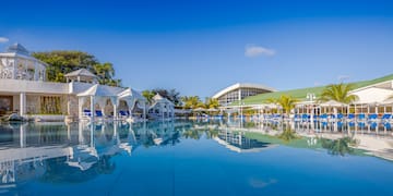 a pool with chairs and umbrellas