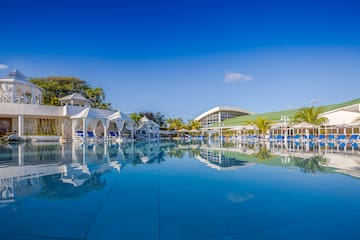 a pool with chairs and umbrellas