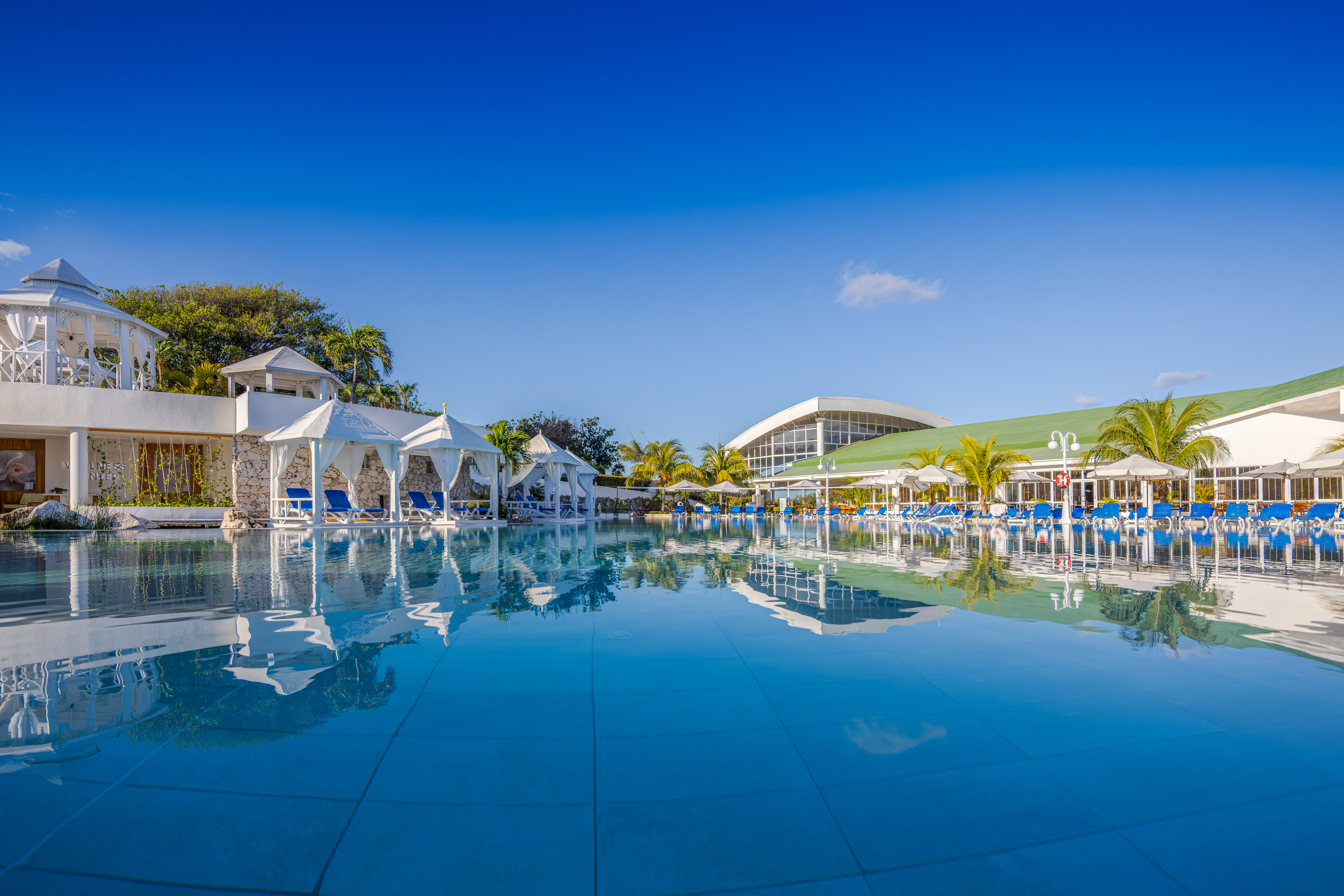 a pool with chairs and umbrellas