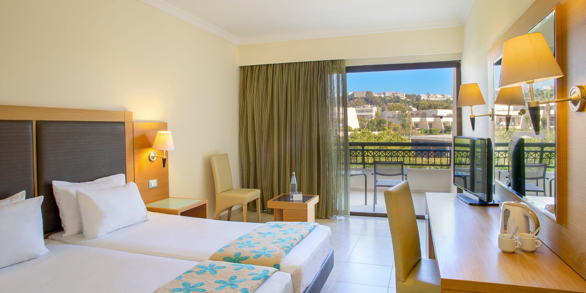 a room with two beds and a television