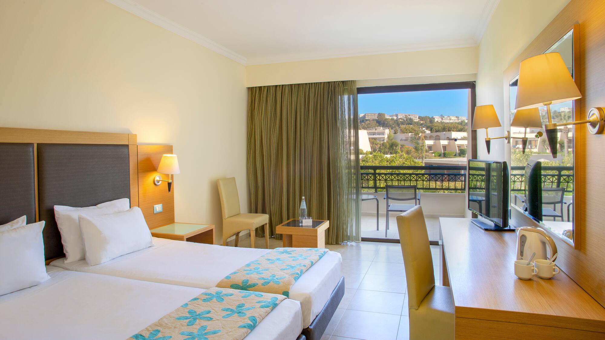 a room with two beds and a television