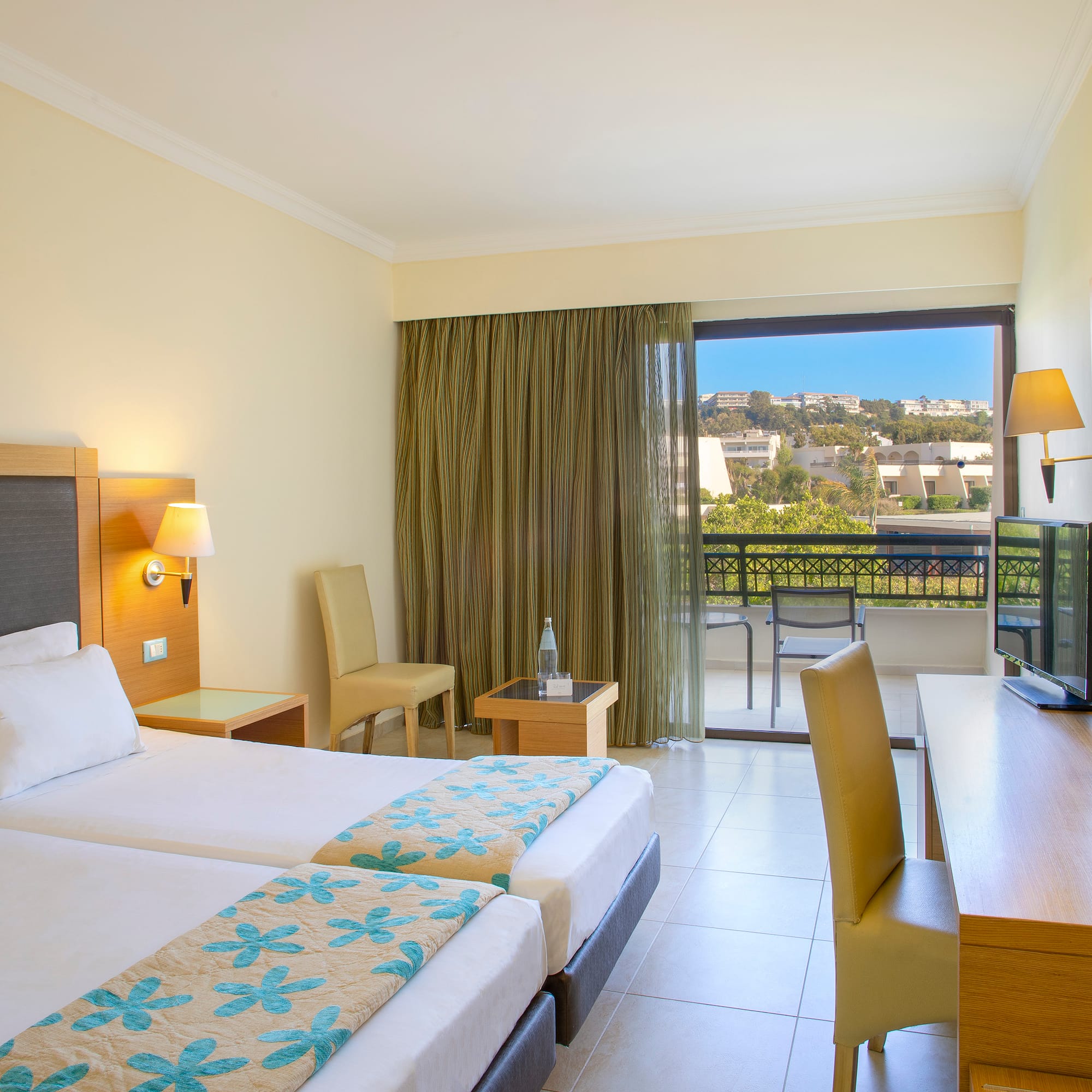 a room with two beds and a television