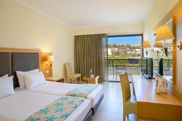 a room with two beds and a television