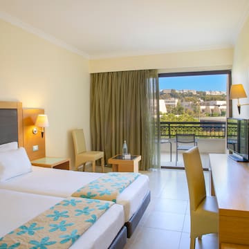 a room with two beds and a television