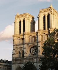 a large building with two towers with Notre Dame de Paris in the background