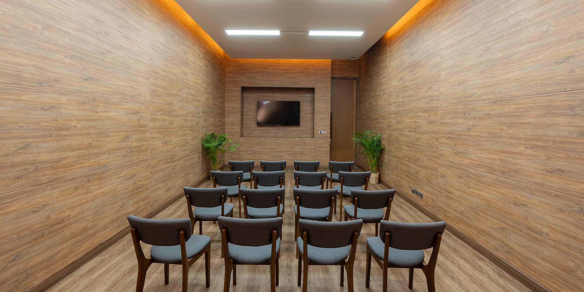 a room with chairs and a television