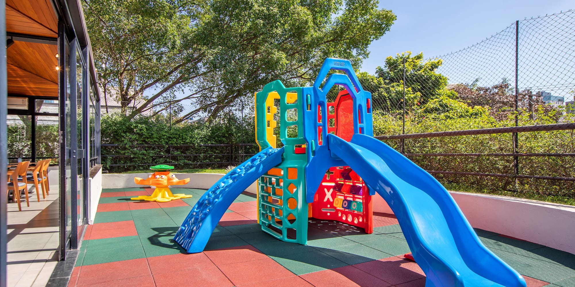 a playground with slide and a swing