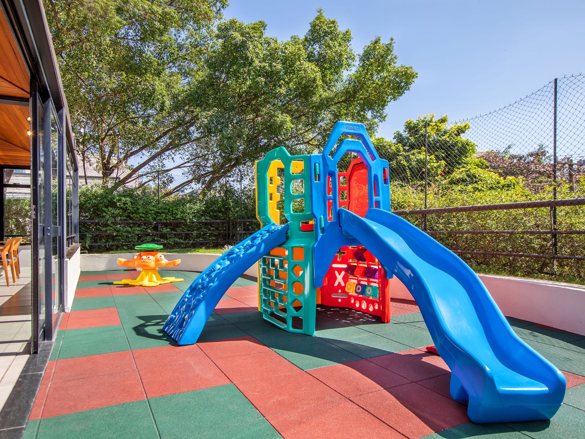 a playground with slide and a swing