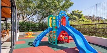 a playground with slide and a swing