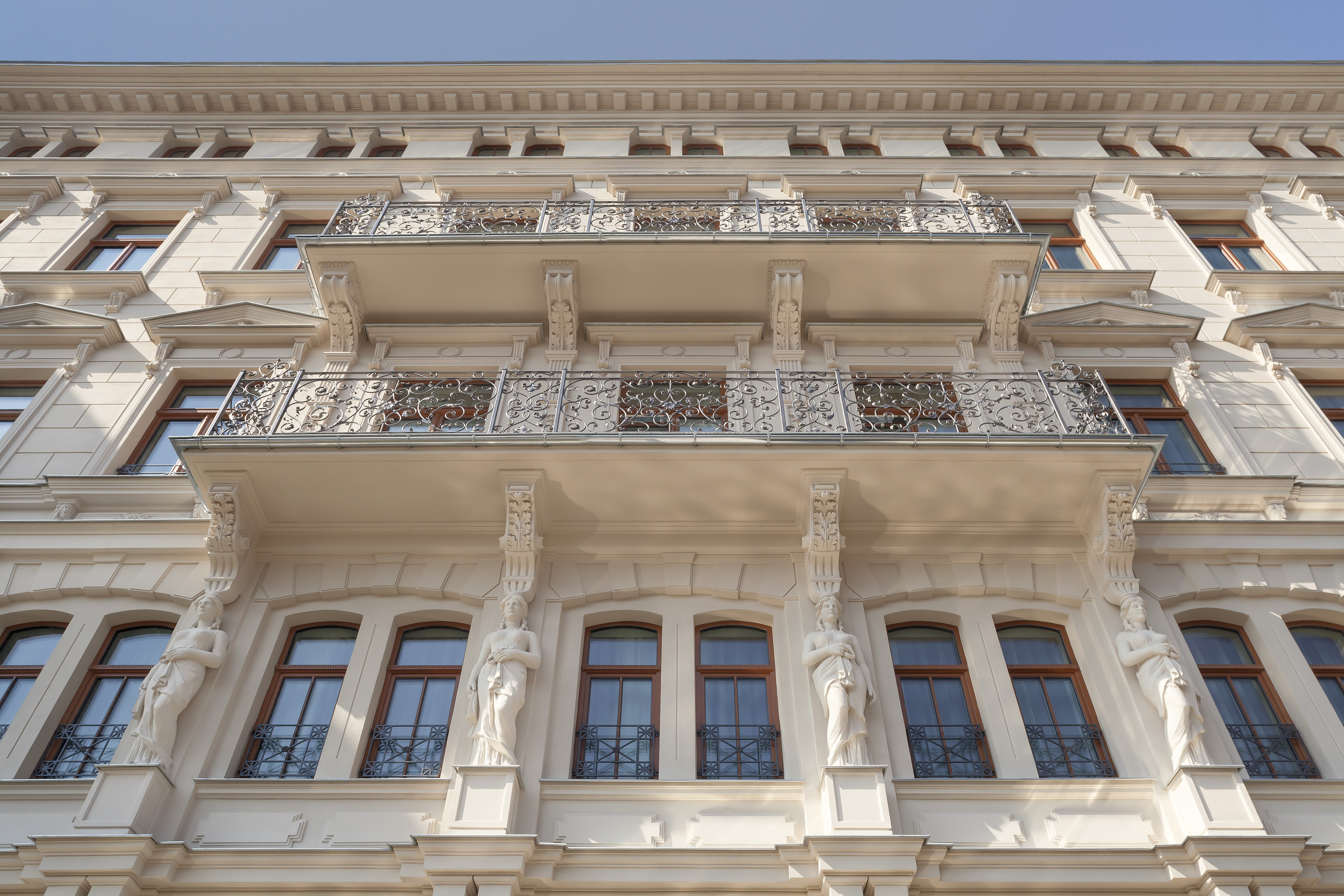 Ornate historic building facade with decorative balconies and statues.