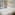 Bright hotel room with large bed, pool view, and balcony overlooking resort.