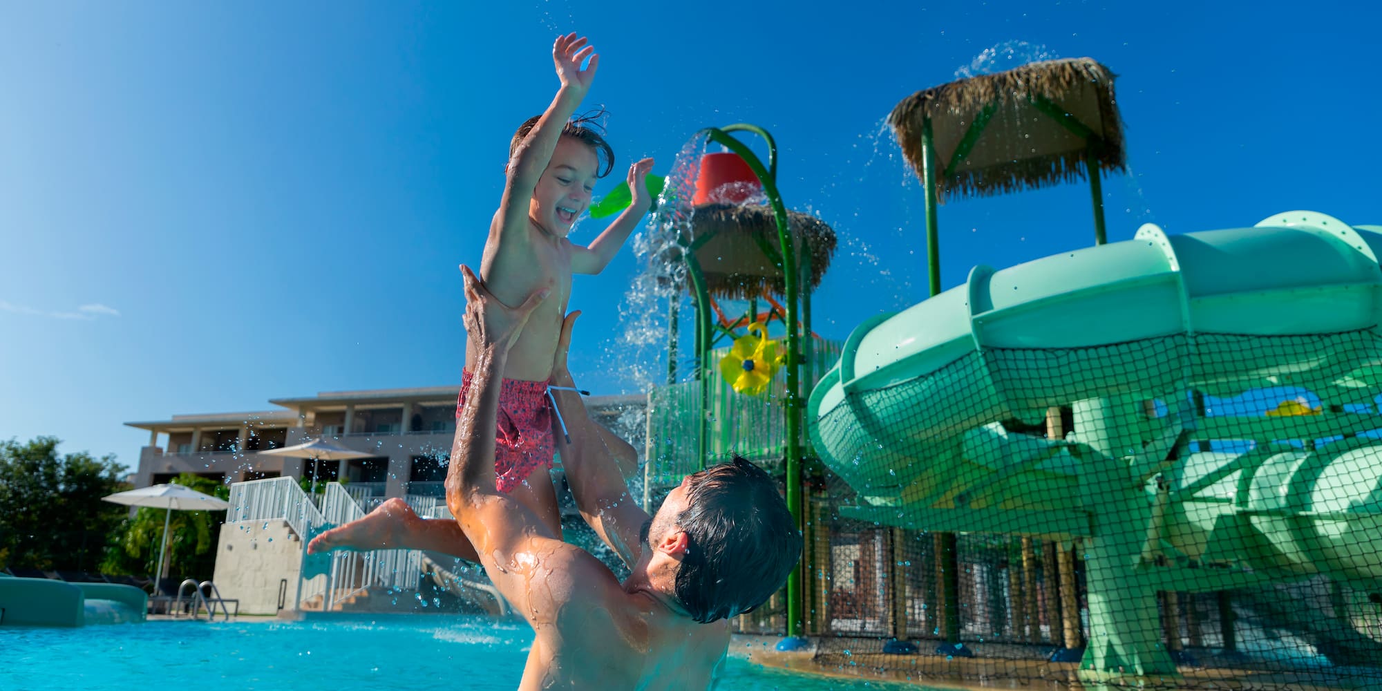 a man and child in a pool