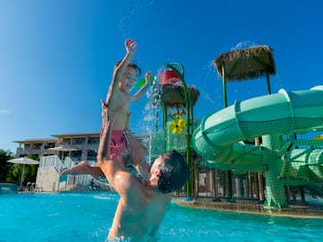a man and child in a pool
