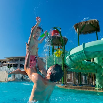 a man and child in a pool