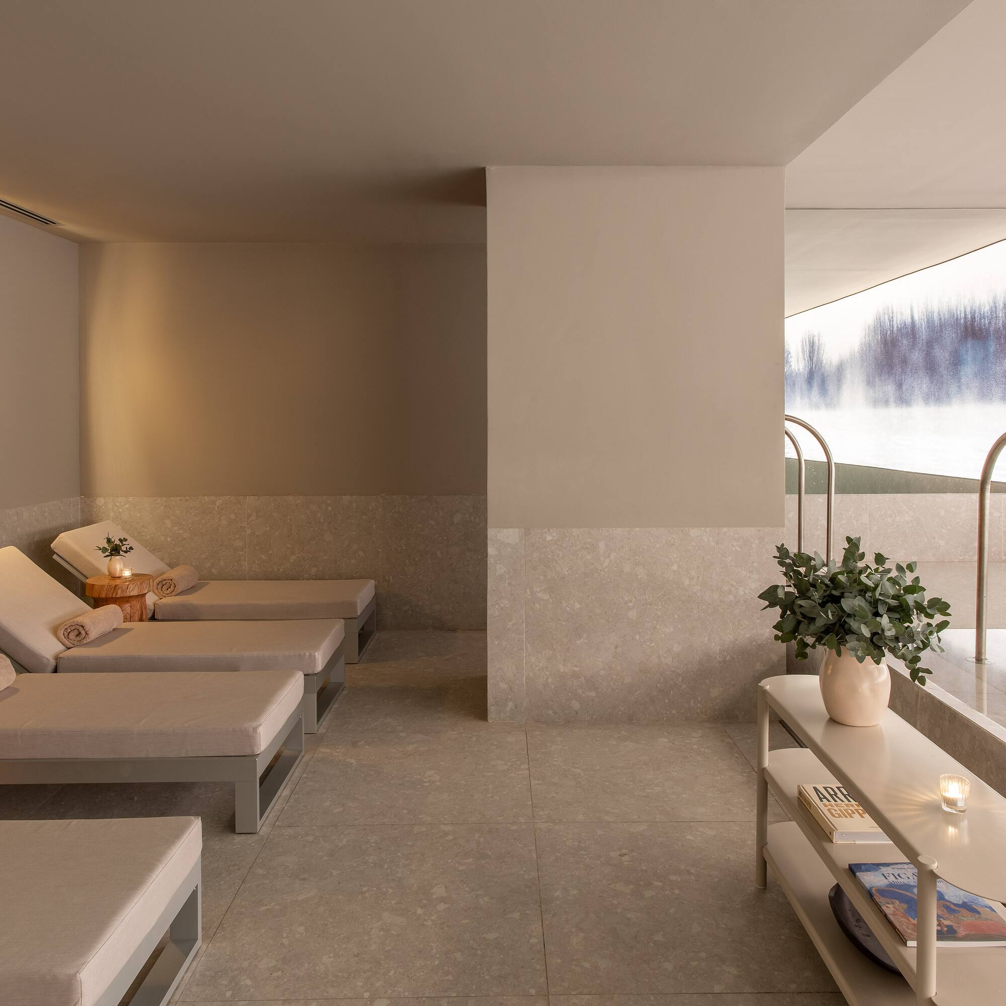a room with chairs and a pool