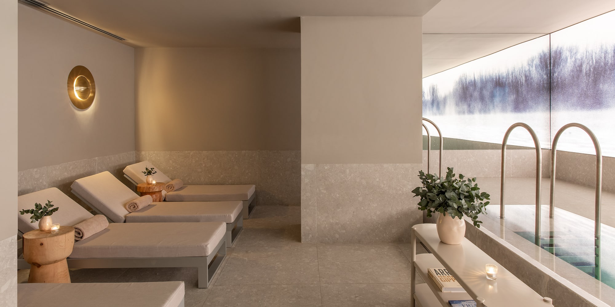 a room with chairs and a pool