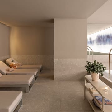 a room with chairs and a pool